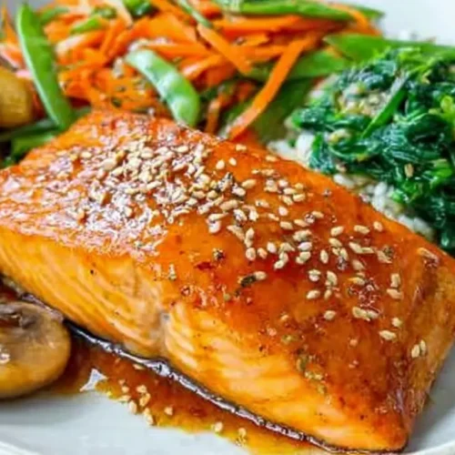 A well-arranged balanced salmon dinner plate with vegetables and grains.