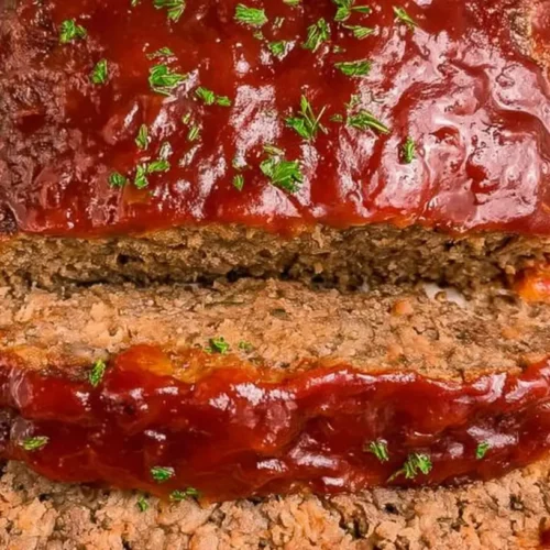 A freshly baked old-school classic meatloaf, perfectly browned and sliced.