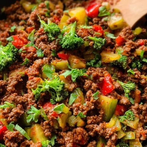 A colorful clean eating ground beef skillet with vegetables on a white plate.