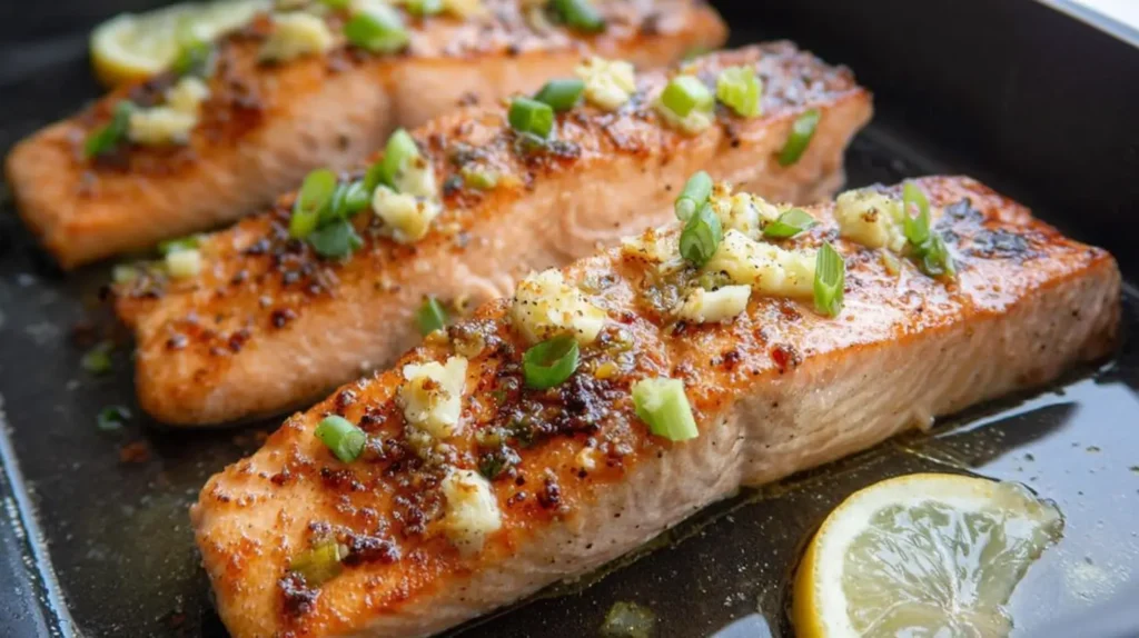 A plate featuring pan seared salmon with a luscious garlic butter glaze