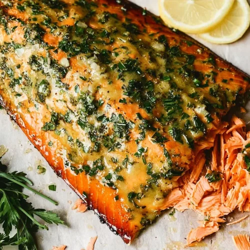 A perfectly cooked, juicy baked salmon fillet on a serving plate.