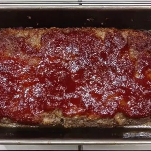 A full low-carb meatloaf dinner, perfectly cooked and sliced, ready to serve.