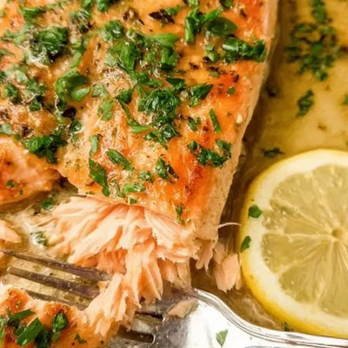 A perfectly cooked piece of no-fuss baked salmon, flaked and ready to eat.