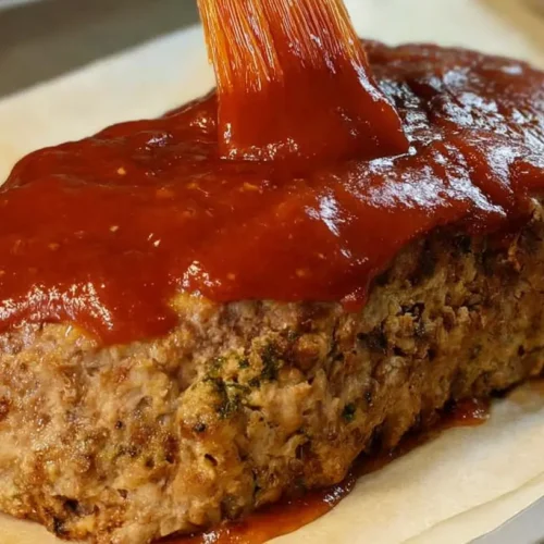 A serving of protein-packed healthy meatloaf on a plate, ready to eat.