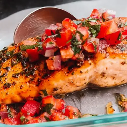 A perfectly cooked quick pan seared salmon fillet, golden-brown and flaky.