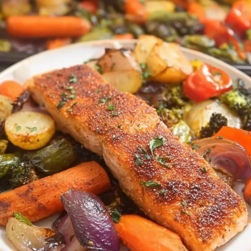A colorful Salmon and Vegetable Sheet Pan Meal with roasted salmon fillets and mixed vegetables.