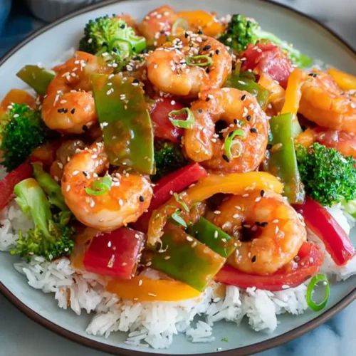 A vibrant shrimp and vegetable stir fry dish presented in a bowl.
