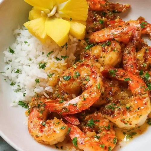 A simple garlic shrimp recipe presented on a white plate.