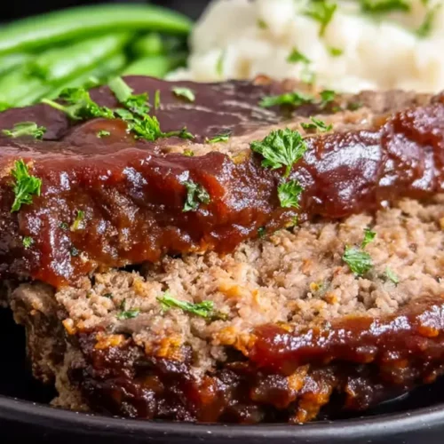 A simple oven baked meatloaf, golden brown and perfectly cooked.