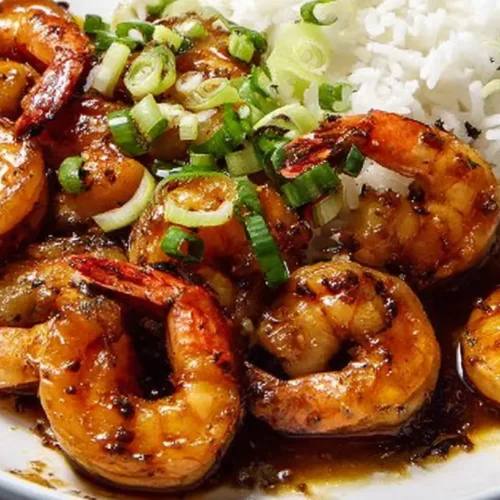 A close-up shot of a plate of Weeknight Garlic Shrimp Dinner, garnished with fresh parsley.