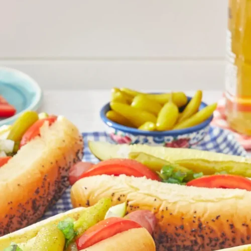 An authentic Chicago style hot dog with all the traditional toppings on a poppy seed bun.
