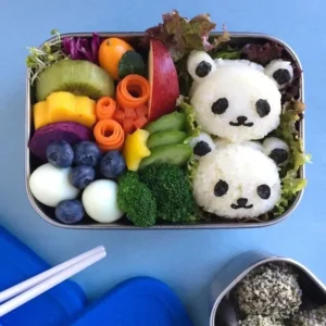 Assorted vibrant kids lunch boxes, bento style, filled with healthy snacks and colorful food.