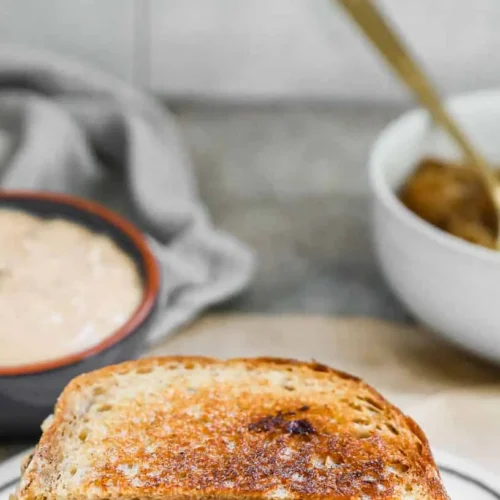 Close-up of a perfectly grilled patty melt sandwich with melted cheese