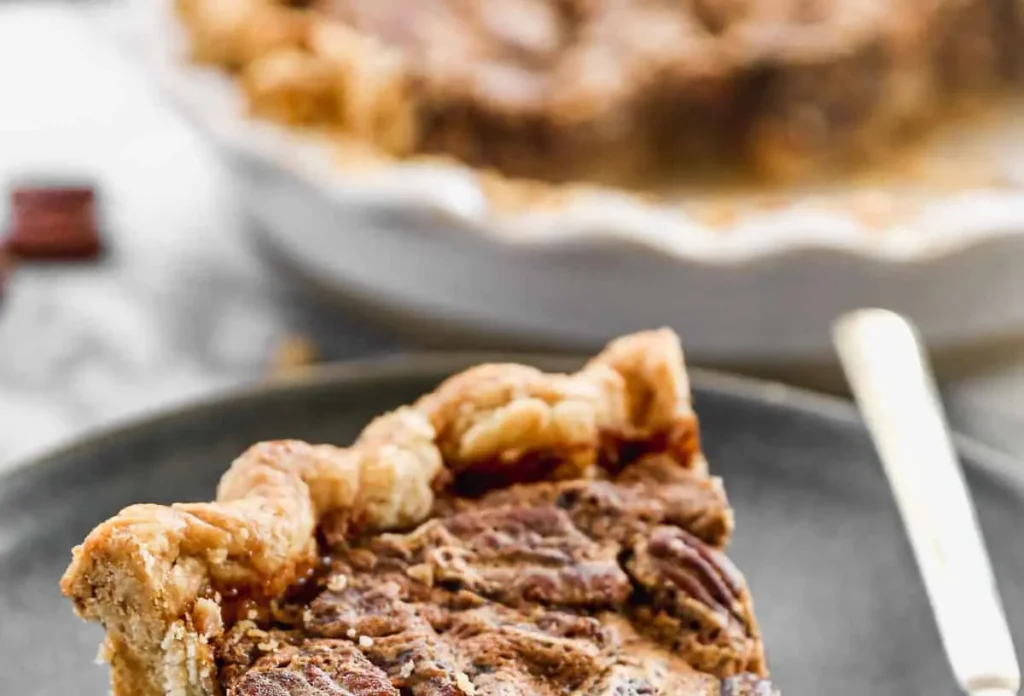 A freshly baked whole pecan pie with a golden crust