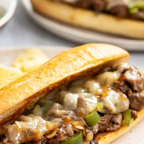 A delicious Philly cheesesteak with melted cheese and tender steak on a long roll