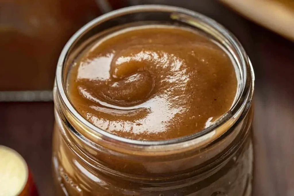 Cooked apples simmering in a slow cooker, transforming into slow cooker apple butter
