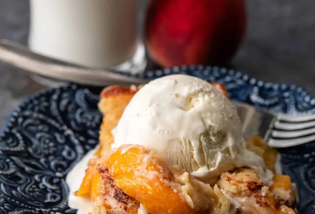 A freshly baked peach cobbler bubbling with fruit